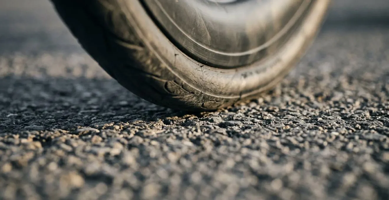 Extreme Nahaufnahme eines Fahrradreifens unter Last mit sichtbarer Kontaktfläche auf Asphalt